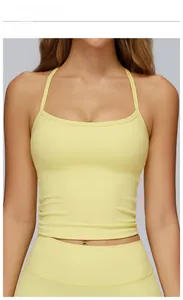 Detail of goose yellow sports yoga vest with racerback design and compression leggings
