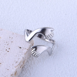 Minimalist silver hugging arms open ring in stainless steel on a white stone background