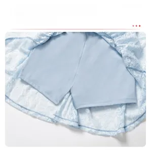 Detailed view of light blue lace dress featuring built-in safety shorts for extra coverage