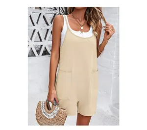 Detail view of khaki sleeveless romper with front pockets and white tank top layered