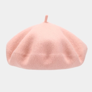 Detail shot of soft pink wool beret showing fine felt texture and classic top stem