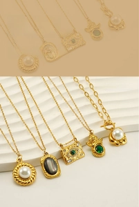 Macro view of 18K gold plated stainless steel necklaces featuring natural stone pendants