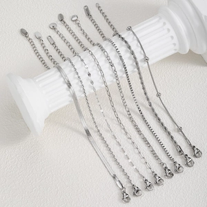Close-up of silver snake and twist chains showing lobster clasps and 316L steel stamps