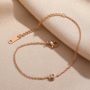 Minimalist rose gold stainless steel bracelet with a single crystal for women