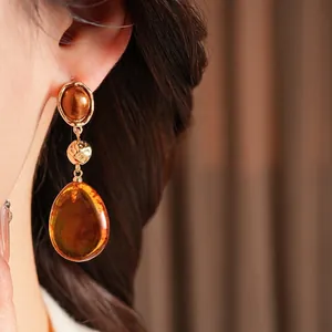 Vintage amber resin water drop earrings with golden metal accents for women