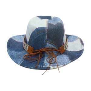 Detail of blue denim cowboy hat with ethnic patterned leather band and string bow