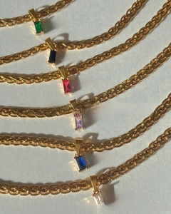 Detail of colorful rectangular zircon pendants on 18k gold plated braided chain necklaces