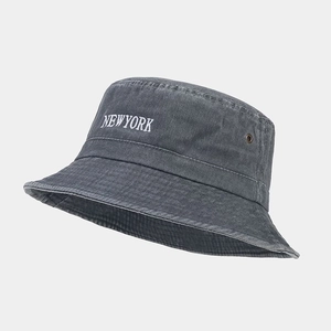 Close-up of washed cotton bucket hat featuring metal eyelet and New York embroidery