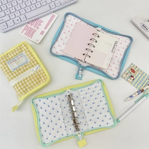 Flat lay of Korean fabric 6-ring binders with zipper closure in various patterns