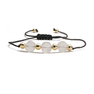 Detail of adjustable handmade rope bracelet with white stone beads and gold metal accents