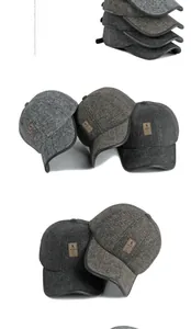 Close-up of thick herringbone wool texture and stitched labels on winter baseball caps