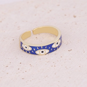 Macro shot of gold adjustable ring featuring blue enamel devil eye and zircon details
