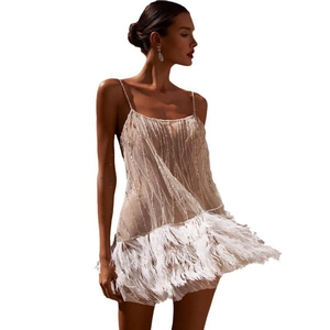 Detail of white sequin cocktail dress featuring tiered feather hem and thin straps