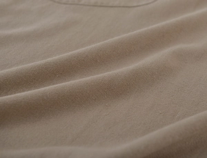 Detailed close-up of beige washed linen fabric texture for minimalist garden aprons