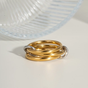 Macro detail of interlinked gold and silver stainless steel rings with polished finish