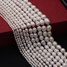 Macro view of natural white freshwater pearls in various sizes and baroque oval shapes