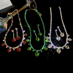 Detailed view of zircon heart fringe jewelry sets in gold, green, and silver finishes