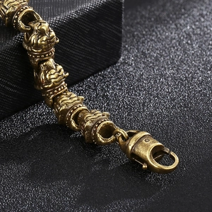 Detailed close-up of retro brass bracelet with dragon carvings on leather background