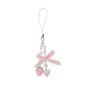 Detail of pink strawberry keychain with silk ribbon bow and heart-shaped pendant charms