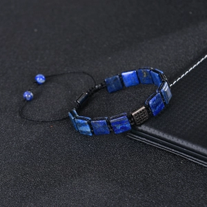 Macro shot of 10x10mm square blue stone with micro-pave zircon on a woven bracelet