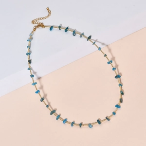 Detailed close-up of blue stone necklace with gold beads, lobster clasp and extender