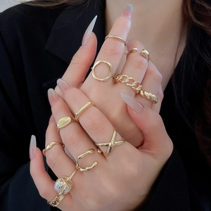 Detailed view of layered gold starfish rings with faux pearls on model's hand