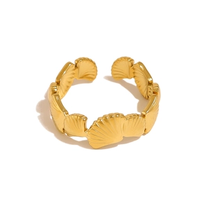 Detail of golden open ring featuring connected scallop shell ocean style design