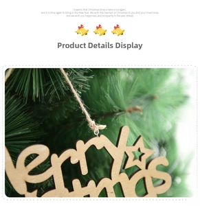 Close-up of wooden Merry Christmas hanging ornament on a green pine tree branch
