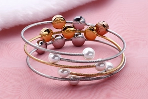 Detail view of multi-layer stainless steel wire bracelet set with beads and pearls
