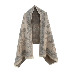 Detail of beige paisley scarf with floral bird patterns and decorative fringe trim