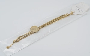 Detail view of 18K gold plated stainless steel layered Cuban chain with queen coin pendant