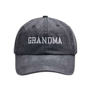 Detail of white GRANDMA embroidery on washed dark grey cotton baseball cap texture