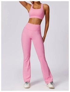 Detail view of pink two-piece yoga set with racerback top and high-waisted flared leggings