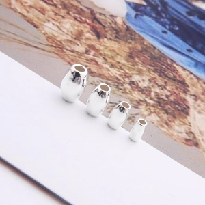 Macro shot of polished S925 sterling silver oval beads in four different sizes for jewelry