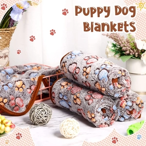Close-up of soft grey fleece pet blanket featuring colorful paw print patterns