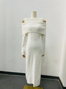 Detail of white off-shoulder knit dress showing elegant ribbed texture and slim-fit cut