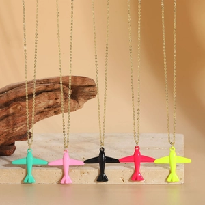Close-up of five colorful airplane necklaces with a smooth paint finish on gold chains