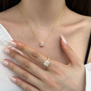 Close-up of S925 silver gold-plated necklace and ring set with square-cut ice zircons
