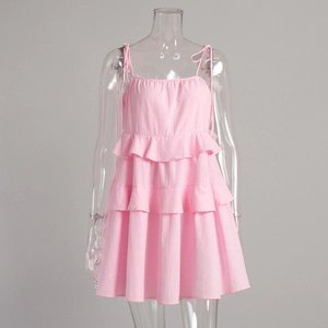 Detail of adjustable shoulder straps and tiered ruffle layers on pink summer dress
