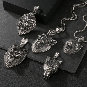 Detail of vintage silver punk animal head pendants featuring lion and wolf designs