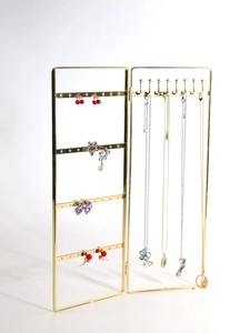 Golden folding metal jewelry display stand with earring holes and necklace hooks