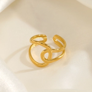 Minimalist 18K gold plated twisted stainless steel ring on silk background