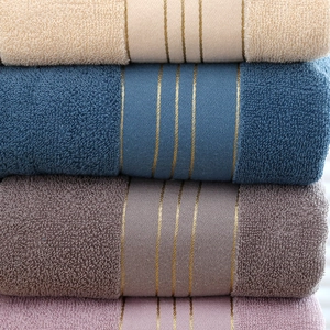Thick cotton bath towel set in beige, cyan, brown, and lilac with gold stripe detail