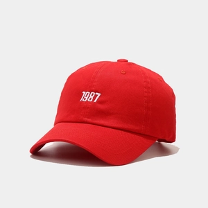 Detail of red 1987 embroidery on a cotton canvas baseball cap with curved brim
