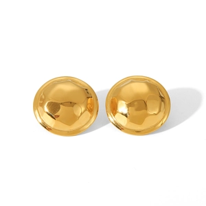 Detail shot of golden spiral stud earrings featuring textured hammered metal finish