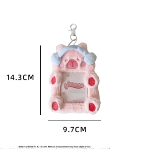 Pink plush demon bear card holder detail with blue headphone and hanging hook