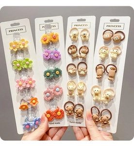 Detail of assorted cute cartoon hair ties featuring bears and flowers for girls