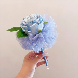 Close-up of a hand holding a creative blue silk rose pen with elegant mesh detail