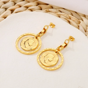 Detailed macro view of vintage gold coin earrings with portrait relief and textured rings