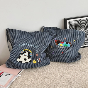 Detail of navy blue striped canvas bag with cute 3D puppy embroidery and typography